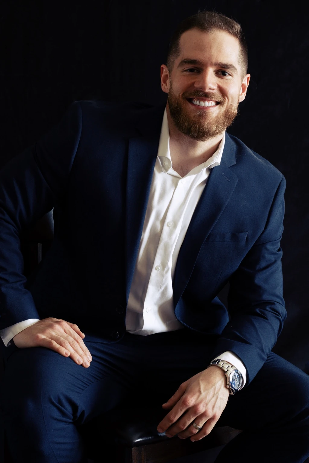 Chris Cox in a navy suit